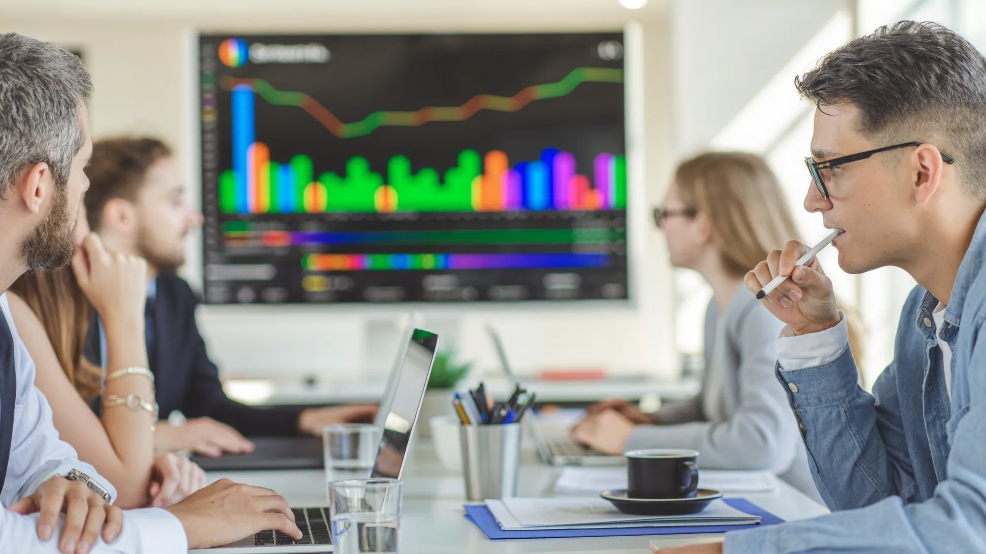 A marketing team collaborating with an analytics dashboard, illustrating AI marketing automation