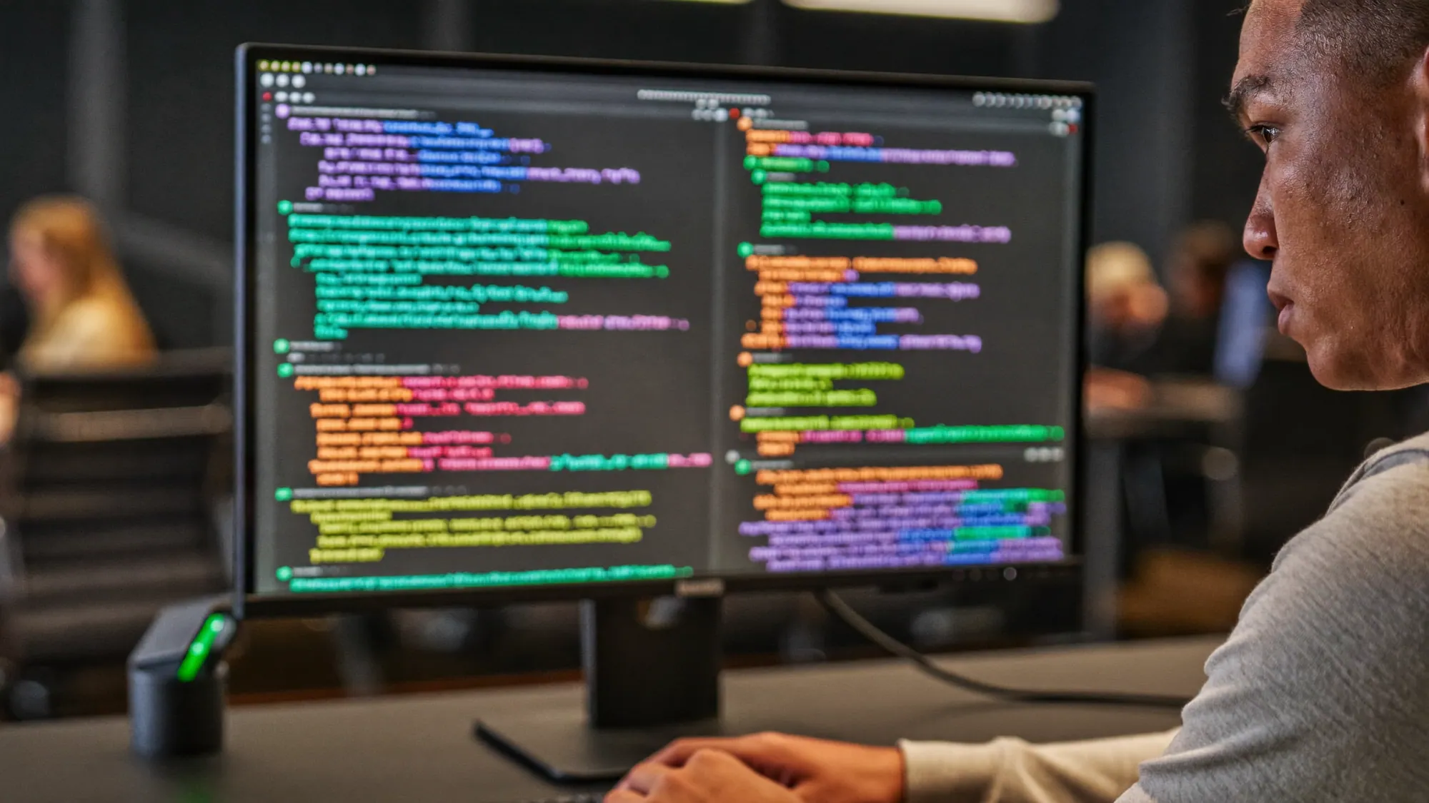 A developer writing code, illustrating the build vs buy software decision