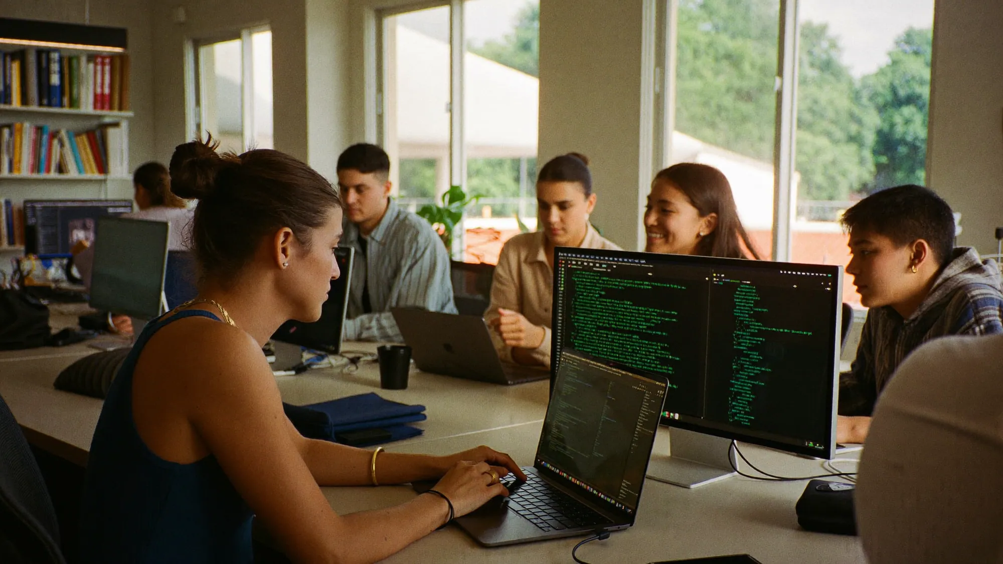 Nearshore software development team in Mexico collaborating in a bright office during shared US business hours