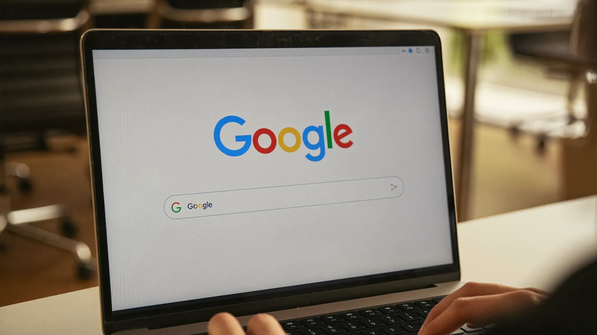 A laptop showing the Google search homepage, illustrating what SEO services are and how they improve search visibility