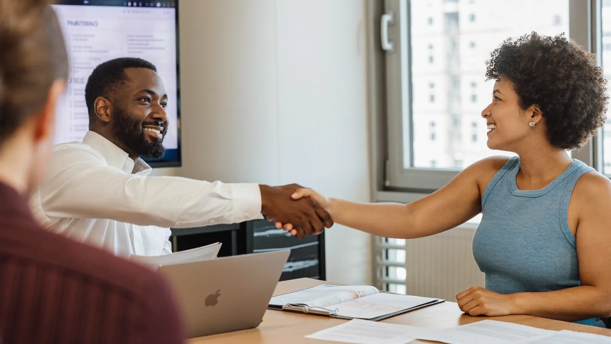 Two professionals shaking hands, choosing the right SEO agency partner
