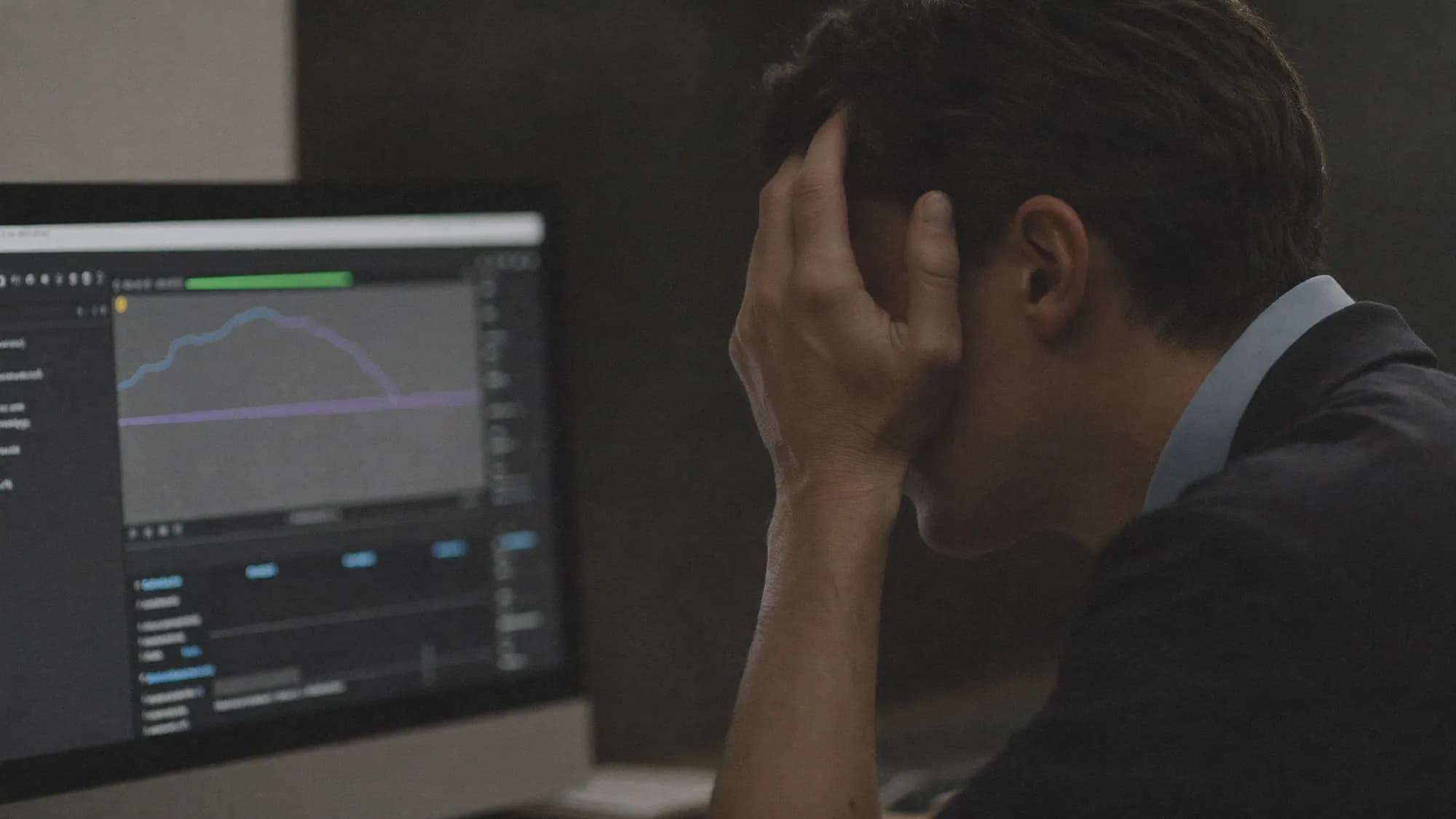 A frustrated sales manager facing a declining dashboard, illustrating why CRM implementations fail