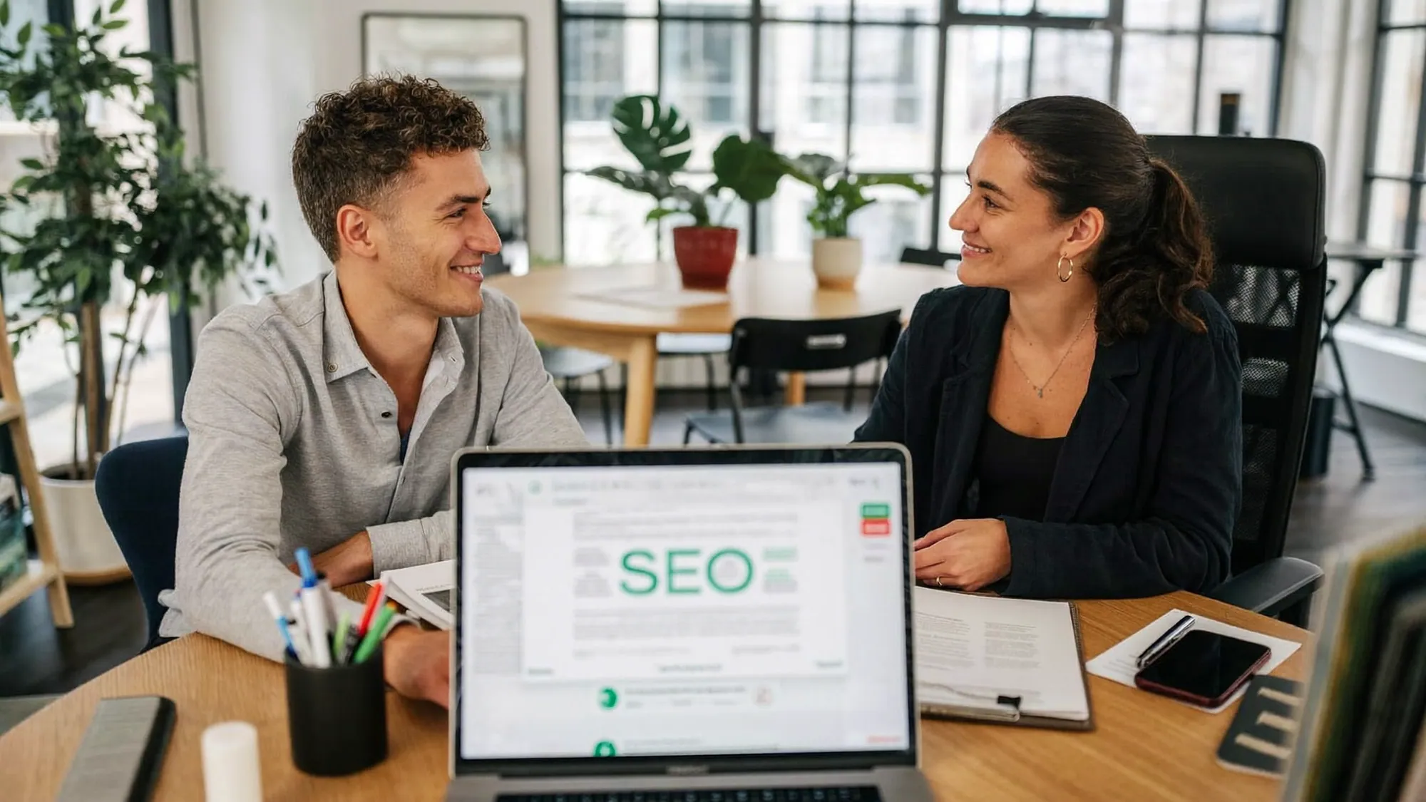 A business owner in a consultation with an SEO specialist asking vetting questions before signing a contract